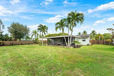 Enjoy easy Florida living in this well-cared-for 3-bedroom on Palm Beach National Golf and Country Club in Florida - for sale on GolfHomes.com, golf home, golf lot