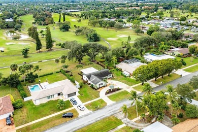 Enjoy easy Florida living in this well-cared-for 3-bedroom on Palm Beach National Golf and Country Club in Florida - for sale on GolfHomes.com, golf home, golf lot