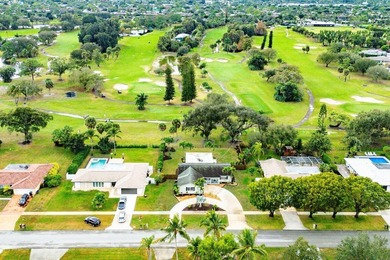 Enjoy easy Florida living in this well-cared-for 3-bedroom on Palm Beach National Golf and Country Club in Florida - for sale on GolfHomes.com, golf home, golf lot