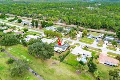 Enjoy easy Florida living in this well-cared-for 3-bedroom on Palm Beach National Golf and Country Club in Florida - for sale on GolfHomes.com, golf home, golf lot