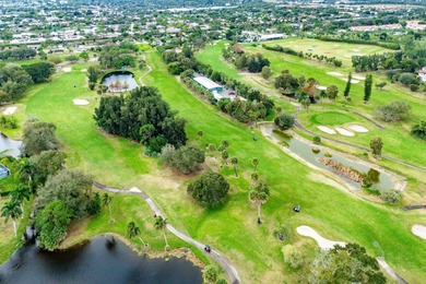 Enjoy easy Florida living in this well-cared-for 3-bedroom on Palm Beach National Golf and Country Club in Florida - for sale on GolfHomes.com, golf home, golf lot