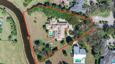 Set on 1.25 acres directly across from PGA National, this estate on  in Florida - for sale on GolfHomes.com, golf home, golf lot