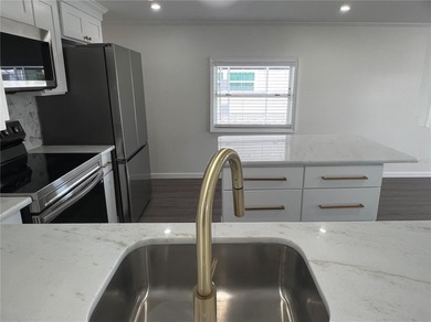 Welcome home to a truly exceptional renovation where modern on Fairway Village Golf Course in Florida - for sale on GolfHomes.com, golf home, golf lot