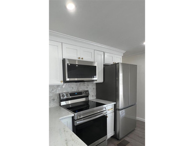 Welcome home to a truly exceptional renovation where modern on Fairway Village Golf Course in Florida - for sale on GolfHomes.com, golf home, golf lot