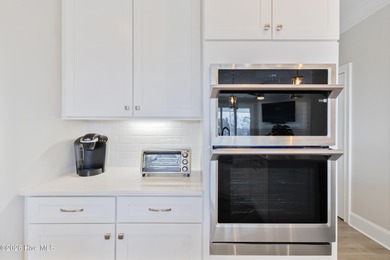 Luxury, views, and location -- this stunning end-unit elevator on Sea Trail Golf Resort in North Carolina - for sale on GolfHomes.com, golf home, golf lot