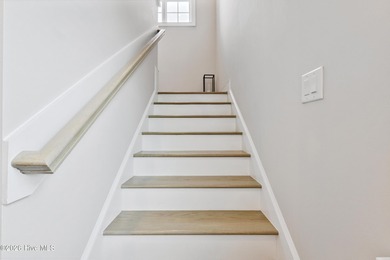 Luxury, views, and location -- this stunning end-unit elevator on Sea Trail Golf Resort in North Carolina - for sale on GolfHomes.com, golf home, golf lot