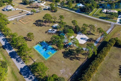 Experience luxury and privacy in this stunning home set on .67 on The Cape Club of Palm City in Florida - for sale on GolfHomes.com, golf home, golf lot