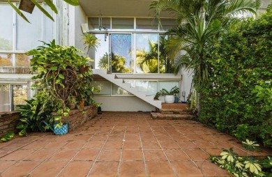 Stunning 3-level with breathtaking golf course and water views on Country Club of Miami in Florida - for sale on GolfHomes.com, golf home, golf lot
