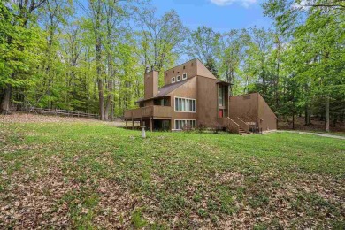Nestled on a serene, wooded lot and backing up to protected on Birchwood Farms Golf and Country Club in Michigan - for sale on GolfHomes.com, golf home, golf lot