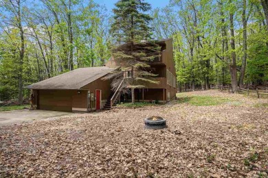 Nestled on a serene, wooded lot and backing up to protected on Birchwood Farms Golf and Country Club in Michigan - for sale on GolfHomes.com, golf home, golf lot
