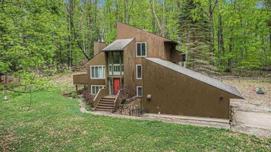 Nestled on a serene, wooded lot and backing up to protected on Birchwood Farms Golf and Country Club in Michigan - for sale on GolfHomes.com, golf home, golf lot