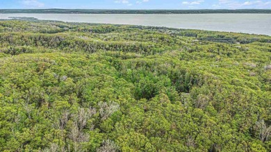 Nestled on a serene, wooded lot and backing up to protected on Birchwood Farms Golf and Country Club in Michigan - for sale on GolfHomes.com, golf home, golf lot
