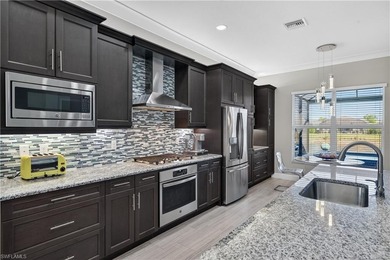 Discover refined lakefront living at 28732 Montecristo Loop in on Palmira Golf and Country Club in Florida - for sale on GolfHomes.com, golf home, golf lot