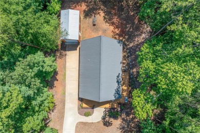 Discover a newer home opposite Hartwell Lake, boasting seasonal on The Trail At Chickasaw Pointe in South Carolina - for sale on GolfHomes.com, golf home, golf lot