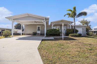 Nestled in the charming community of Barefoot Bay, this stunning on Barefoot Bay Golf Course in Florida - for sale on GolfHomes.com, golf home, golf lot