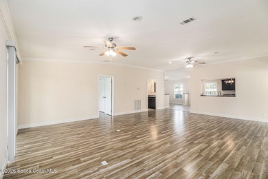 Nestled in the charming community of Barefoot Bay, this stunning on Barefoot Bay Golf Course in Florida - for sale on GolfHomes.com, golf home, golf lot