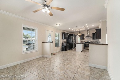 Nestled in the charming community of Barefoot Bay, this stunning on Barefoot Bay Golf Course in Florida - for sale on GolfHomes.com, golf home, golf lot