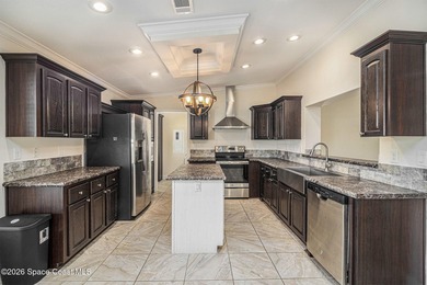 Nestled in the charming community of Barefoot Bay, this stunning on Barefoot Bay Golf Course in Florida - for sale on GolfHomes.com, golf home, golf lot