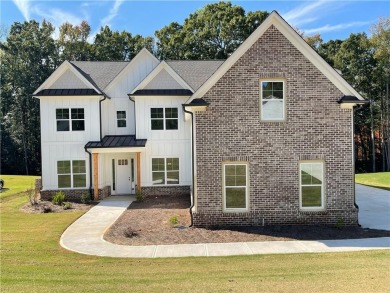 Stunning 2-story home with a 3rd car garage in a coveted on Traditions of Braselton Golf Club in Georgia - for sale on GolfHomes.com, golf home, golf lot