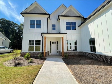 Stunning 2-story home with a 3rd car garage in a coveted on Traditions of Braselton Golf Club in Georgia - for sale on GolfHomes.com, golf home, golf lot