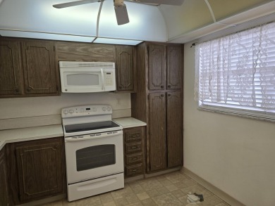 CONVENIENTLY LOCATED ACROSS FROM THE CLUBHOUSE & 2 POOLS, THIS on Poinciana Golf Club in Florida - for sale on GolfHomes.com, golf home, golf lot