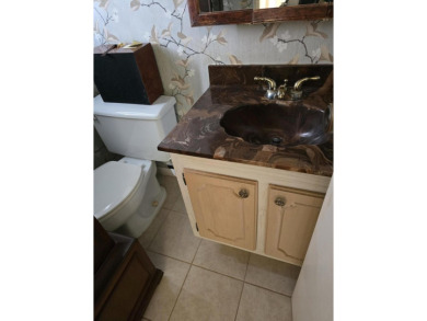 CONVENIENTLY LOCATED ACROSS FROM THE CLUBHOUSE & 2 POOLS, THIS on Poinciana Golf Club in Florida - for sale on GolfHomes.com, golf home, golf lot