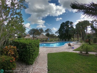 55+ adult community. *CONVENIENT 1ST FLOOR CORNER UNIT WITH on Woodlands Country Club in Florida - for sale on GolfHomes.com, golf home, golf lot