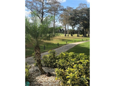 55+ adult community. *CONVENIENT 1ST FLOOR CORNER UNIT WITH on Woodlands Country Club in Florida - for sale on GolfHomes.com, golf home, golf lot