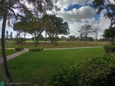 55+ adult community. *CONVENIENT 1ST FLOOR CORNER UNIT WITH on Woodlands Country Club in Florida - for sale on GolfHomes.com, golf home, golf lot