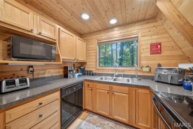 Welcome to 1746 Sonnenblick Drive -- a stunning chalet retreat on Innsbrook Resort Golf Course in Missouri - for sale on GolfHomes.com, golf home, golf lot