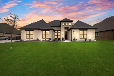 Welcome to this stunning custom-built single-story home on The Golf Club at Resort Eagle Mountain Lake in Texas - for sale on GolfHomes.com, golf home, golf lot
