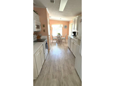 This move-in-ready gem has 2 bedrooms, 2 baths, and is located on Sabal Springs Golf and Racquet Club in Florida - for sale on GolfHomes.com, golf home, golf lot