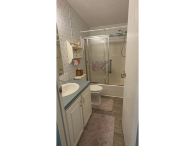 This move-in-ready gem has 2 bedrooms, 2 baths, and is located on Sabal Springs Golf and Racquet Club in Florida - for sale on GolfHomes.com, golf home, golf lot