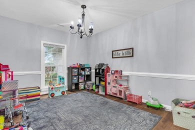 Tucked away on a spacious, pie-shaped lot, this hidden gem on on Olde Point Golf and Country Club in North Carolina - for sale on GolfHomes.com, golf home, golf lot