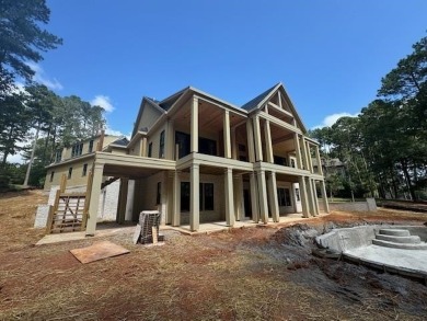 Indulge in opulent living within this custom 5-bedroom, 5.5-bath on Reynolds Lake Oconee - The Oconee in Georgia - for sale on GolfHomes.com, golf home, golf lot