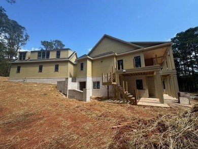 Indulge in opulent living within this custom 5-bedroom, 5.5-bath on Reynolds Lake Oconee - The Oconee in Georgia - for sale on GolfHomes.com, golf home, golf lot