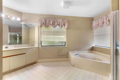 This single family pool home is nestled on a lush and tropical on The Wanderers Club in Florida - for sale on GolfHomes.com, golf home, golf lot