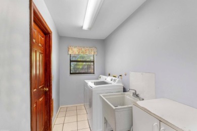 This single family pool home is nestled on a lush and tropical on The Wanderers Club in Florida - for sale on GolfHomes.com, golf home, golf lot