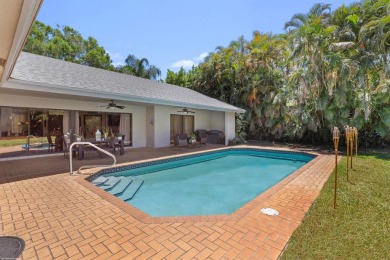 This single family pool home is nestled on a lush and tropical on The Wanderers Club in Florida - for sale on GolfHomes.com, golf home, golf lot