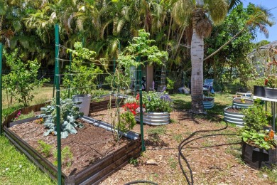This single family pool home is nestled on a lush and tropical on The Wanderers Club in Florida - for sale on GolfHomes.com, golf home, golf lot