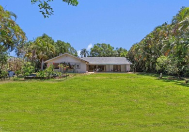 This single family pool home is nestled on a lush and tropical on The Wanderers Club in Florida - for sale on GolfHomes.com, golf home, golf lot