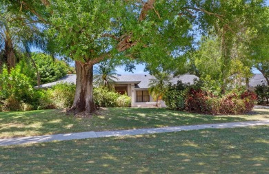 This single family pool home is nestled on a lush and tropical on The Wanderers Club in Florida - for sale on GolfHomes.com, golf home, golf lot