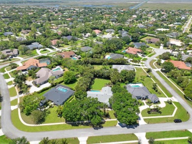 This single family pool home is nestled on a lush and tropical on The Wanderers Club in Florida - for sale on GolfHomes.com, golf home, golf lot