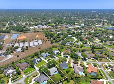 This single family pool home is nestled on a lush and tropical on The Wanderers Club in Florida - for sale on GolfHomes.com, golf home, golf lot