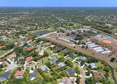 This single family pool home is nestled on a lush and tropical on The Wanderers Club in Florida - for sale on GolfHomes.com, golf home, golf lot