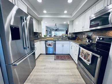 BEAUTIFUL CORNER UNIT WITH EAST EXPOSURE, LAKE, GOLF COURSE, AND on  in Florida - for sale on GolfHomes.com, golf home, golf lot