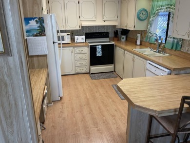 TIRED OF SNOW,ICE AND COLD, TRADE IT IN FOR SUN,WARM AND WHITE on Pine Lakes Country Club in Florida - for sale on GolfHomes.com, golf home, golf lot