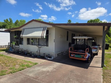 This 2/1.5 manufactured home is priced to sell. It is nestled up on Lake Henry Golf Club in Florida - for sale on GolfHomes.com, golf home, golf lot