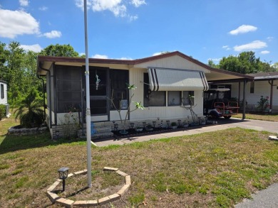 This 2/1.5 manufactured home is priced to sell. It is nestled up on Lake Henry Golf Club in Florida - for sale on GolfHomes.com, golf home, golf lot