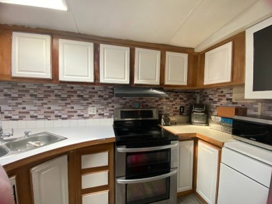This 2/1.5 manufactured home is priced to sell. It is nestled up on Lake Henry Golf Club in Florida - for sale on GolfHomes.com, golf home, golf lot